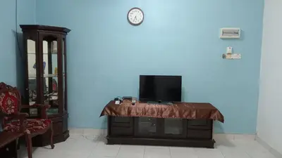 a tv sitting on top of a table in a room at Eyna Homestay in Sitiawan