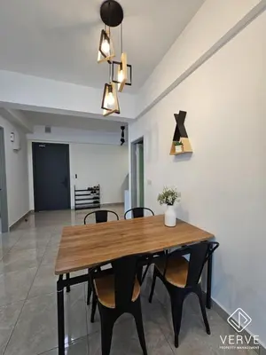 a dining room with a wooden table and chairs at Ipoh Town ICC Premium Suites by Verve 2B2B in Ipoh