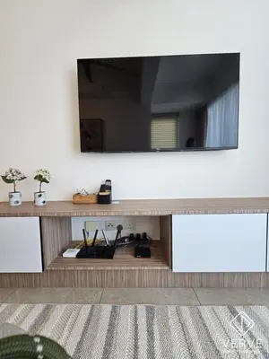 a living room with a large mirror on a wall at Ipoh Town ICC Premium Suites by Verve 2B2B in Ipoh