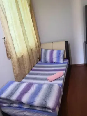 a room with two beds with pillows and a window at The Haven 3 rooms residence Ipoh in Ipoh