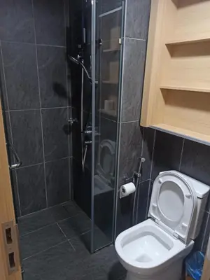 a bathroom with a toilet and a glass shower at Kuala Lumpur in Gua Sai