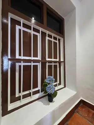 a window with a vase of flowers on a window sill at Popular! 4 pax Georgetown Heritage Pre-war House 2 Bedroom in George Town