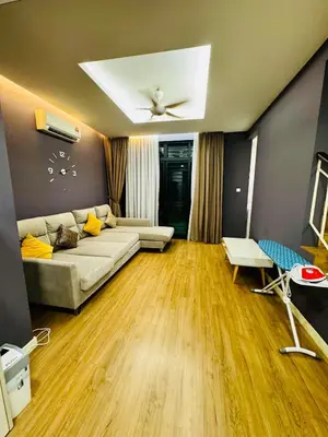 a living room with a couch and a ceiling fan at Batu Ferringhi PoolBBQ 5minBeach Night Market20pax in Batu Ferringhi