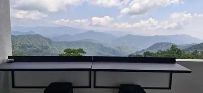 a balcony with a view of a mountain range at B661 SilverparkResort -walk up in Bukit Fraser