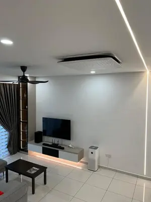 a living room with a tv on a white wall at Cozy Home Simpang Ampat in Simpang Ampat