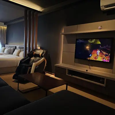 a hotel room with a television and a bed at Black Martini Premium Suite in Tanjong Tokong