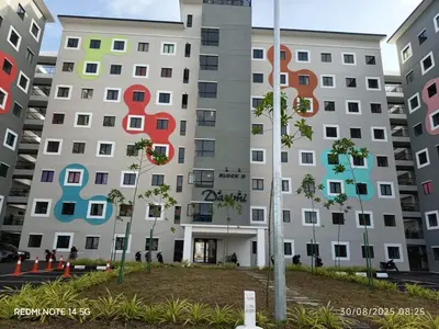 a building with colorful windows and trees in front of it at ZIE HOMESTAY AT SOHO Seri Iskandar in Seri Iskandar