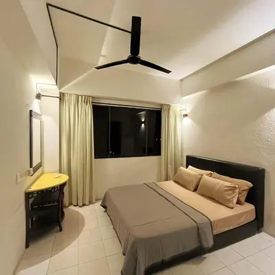 a bedroom with a bed and a ceiling fan at Batu Ferringhi Sri Sayang in Batu Ferringhi