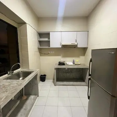 a small kitchen with a sink and a refrigerator at Batu Ferringhi Sri Sayang in Batu Ferringhi