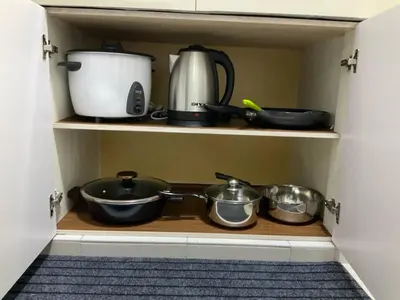 a pantry with pots and pans on a shelf at Horizon Luxe WiFi n KTV in Sitiawan