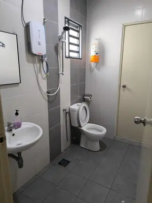 a bathroom with a toilet and a sink at De' Jamboree Homestay in Batu Gajah