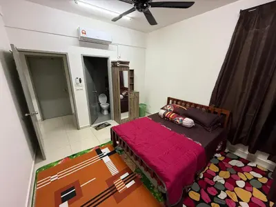 a bedroom with a bed with a red blanket at HSL Homestay Meru in Ipoh