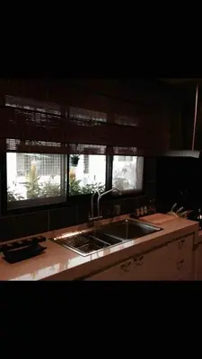 a kitchen with a sink and two windows at Miracle Suite in Ipoh