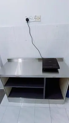 a desk with a laptop sitting on top of it at 3-Bedroom Homelike Apartment in Bukit Mertajam in Bukit Mertajam