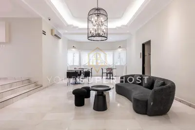 a living room with a couch and a table at 8 Concordia by YourSuperHost in George Town