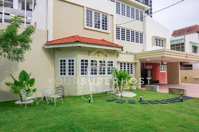 a house with a lawn in front of it at 8 Concordia by YourSuperHost in George Town