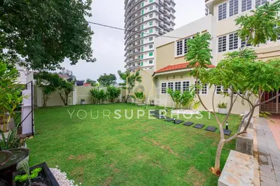 a lawn in front of a building at 8 Concordia by YourSuperHost in George Town