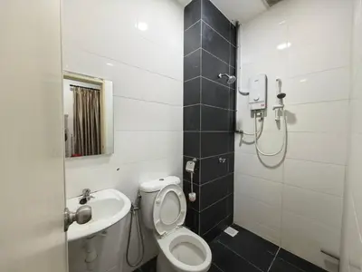 a bathroom with a toilet and a sink at Bertam Holiday Homestay 01 in Kepala Batas