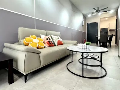 a living room with a couch and a table at Aston Acacia Residence Bukit Mertajam in Bukit Mertajam