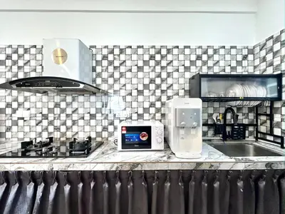 a kitchen with a sink and a counter top with a appliance at Aston Acacia Residence Bukit Mertajam in Bukit Mertajam