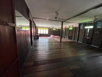 an empty hallway of a building with a room with windows at Homestay wak saripan Rumah Kayu in Teluk Intan