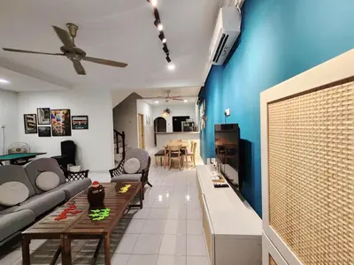 a living room with a couch and a table at Ipoh pasir puteh vibrant home 4br 15 pax in Ipoh