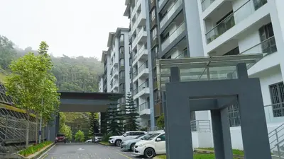 a parking lot with cars parked in front of a building at Palas Horizon By Lume' Living Homestay near Kea Farm Market, 2Bedroom, Sunrise View in Brinchang