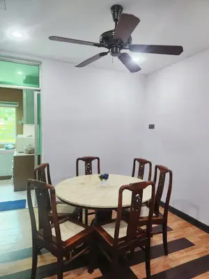 a dining room table with four chairs and a ceiling fan at Ipoh Tambun pool villa 5br20pax bbq karaoke mahjong in Ipoh