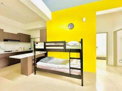 a room with two bunk beds and a yellow wall at Homestay Golden Hills in Brinchang