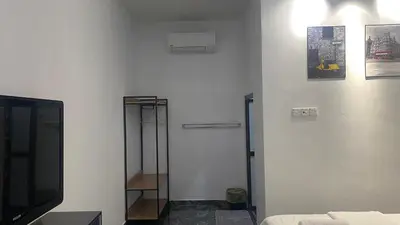 a room with a bed and a tv and a mirror at Capital O 91205 Palong Hill Chalet & Resort in Baling
