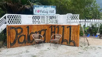 two chairs and a fence with graffiti on it at Capital O 91205 Palong Hill Chalet & Resort in Baling