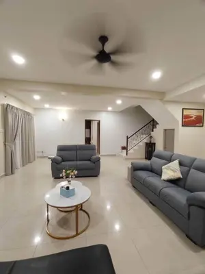 a living room with two couches and a ceiling fan at Ipoh Calm Corner in Ipoh