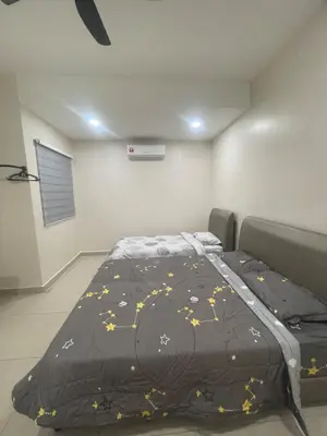 a bedroom with a bed with a black comforter at Ipoh Calm Corner in Ipoh
