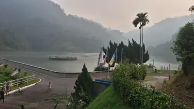 a boat in a lake with a palm tree at Penang Hill Lodge in Ayer Itam