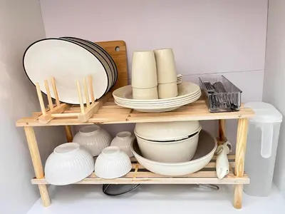 a wooden shelf with dishes and plates on it at NAZS Homestay 4 bilik tidur 3 bilik air in Sungai Petani