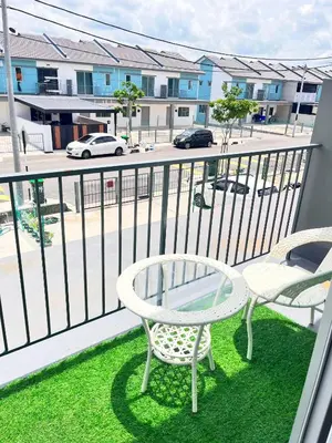 a balcony with two chairs and a table and a street at NAZS Homestay 4 bilik tidur 3 bilik air in Sungai Petani