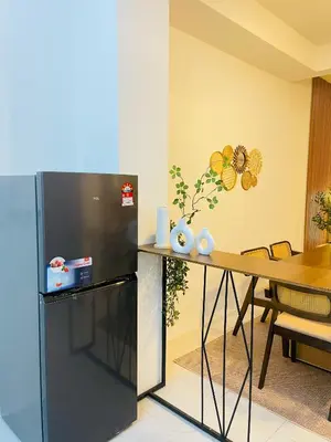 a refrigerator and a table in a room at NAZS Homestay 4 bilik tidur 3 bilik air in Sungai Petani
