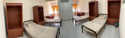 a hospital room with several beds and cabinets at Railway Hostel in Batu Gajah