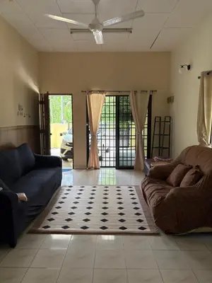 a living room with two couches and a rug at Nadis Guesthouse in Ipoh