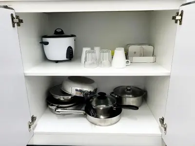 a shelf with pots and pans and other kitchen items at Awan Homestay Cameron Highlands in Tanah Rata