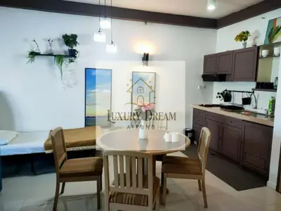 a kitchen and dining room with a table and chairs at Luxury Dream Seaview in Tanjung Bungah