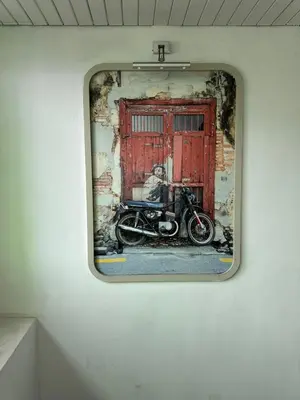 a picture of a motorcycle in front of a red door at Embassy Hotel Georgetown in George Town