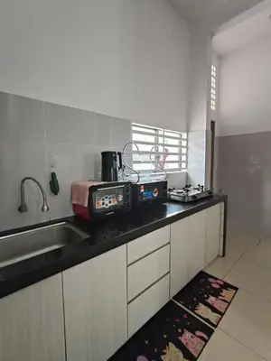 a kitchen with a sink and a counter top at Bertam Perdana Homestay