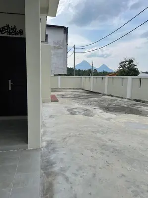 an empty parking lot in front of a building at The Indah Homestay Gerik in Gerik