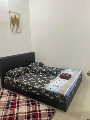 a small bed in a room with a bed sidx sidx at The Indah Homestay Gerik in Gerik