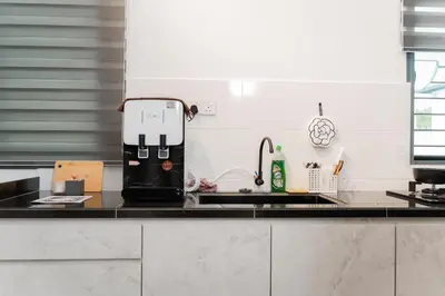 a coffee maker sitting on a counter in a kitchen at SpaciousFun4BR Home 9Pax 3Bath Snooker ALMA in Bukit Mertajam