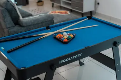 a pool table with balls and cuesticks on it at SpaciousFun4BR Home 9Pax 3Bath Snooker ALMA in Bukit Mertajam