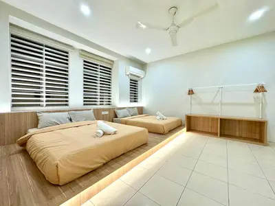 a large bedroom with two beds and a couch at Klebang Cozy Homestay in Chemor