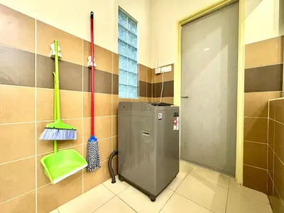 a bathroom with a washing machine and mop at Klebang Cozy Homestay in Chemor
