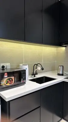 a kitchen with a sink and a microwave at Ipoh city view Luxury suites near Ipoh Parade in Ipoh